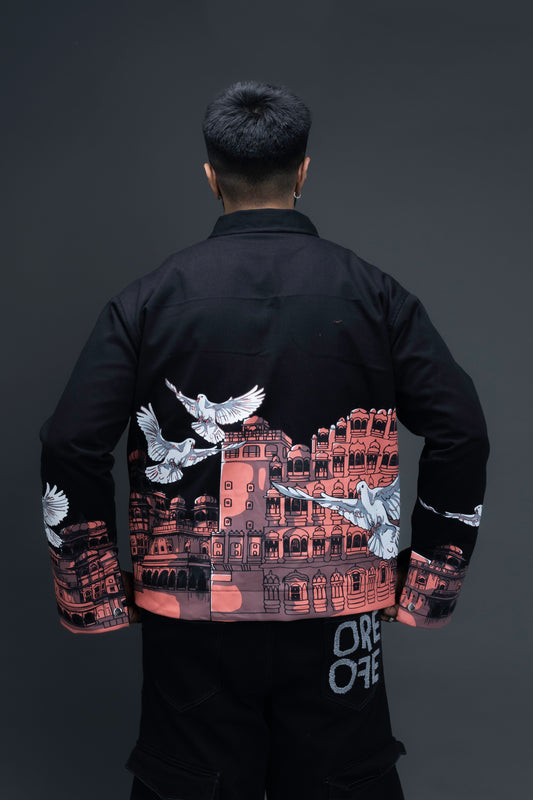 Man wearing ORE OFE's heritage black jacket that is designed on the theme of Hawa mahal standing against a grey background