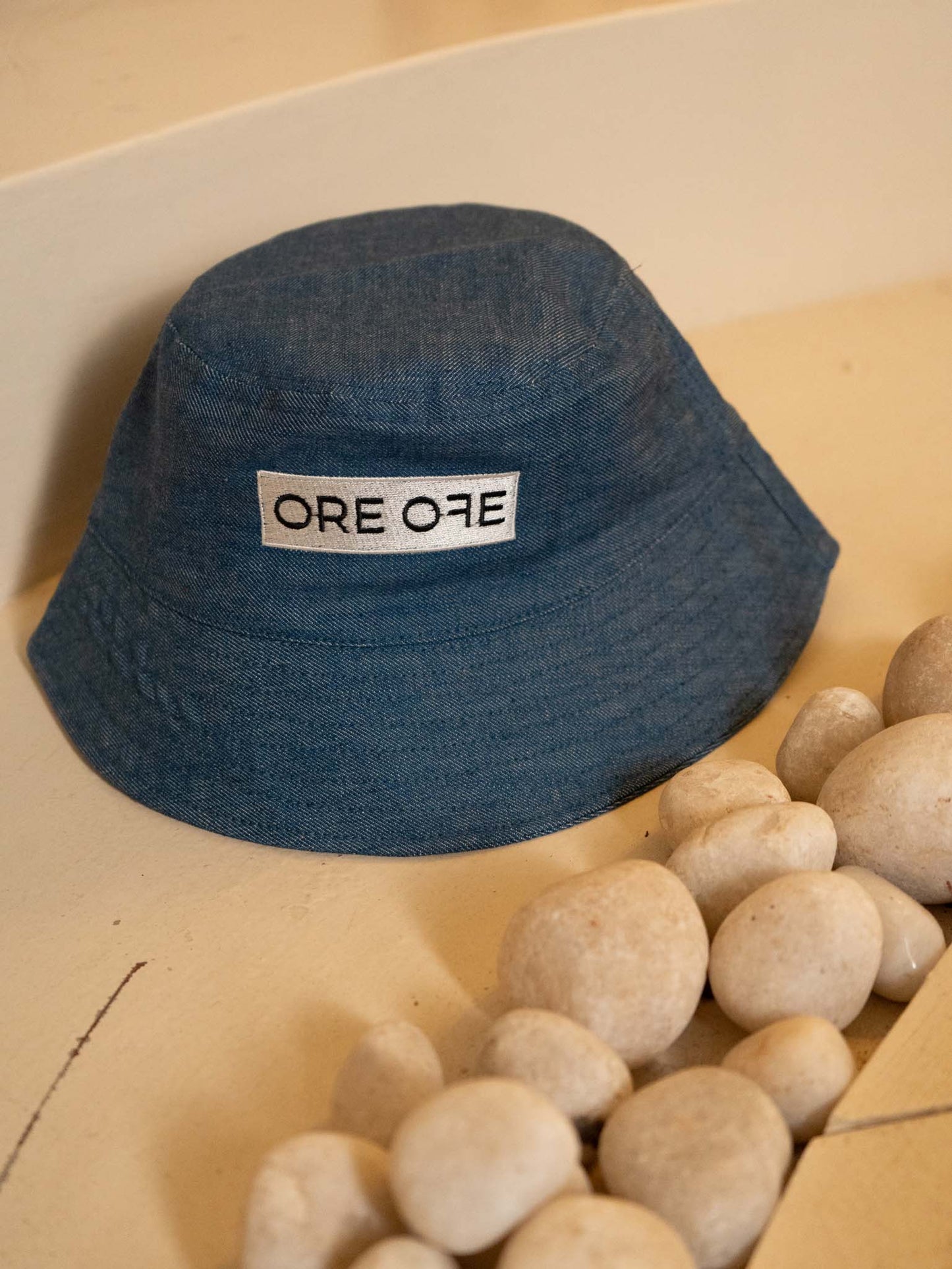 Blue bucket hat with ORE OFE's logo