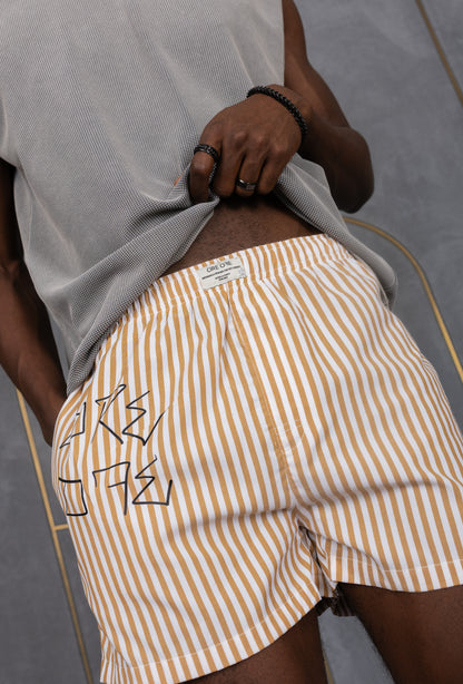 Model wearing a light brown striped ORE OFE boxers with our logo