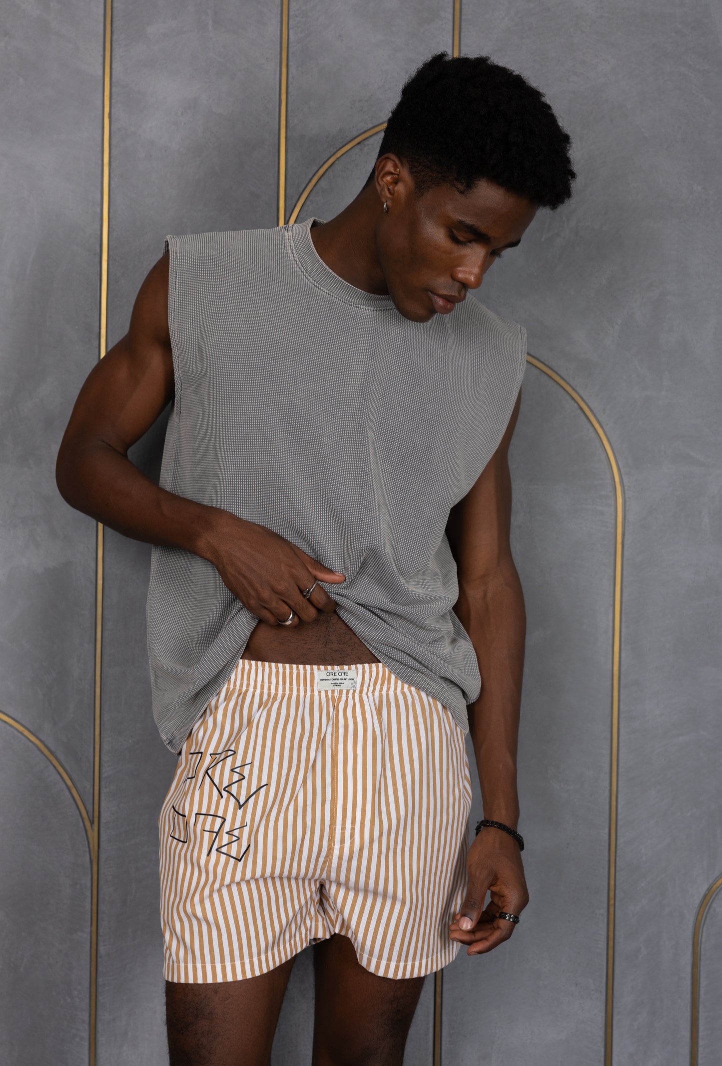 Model wearing a light brown striped ORE OFE boxers with our logo