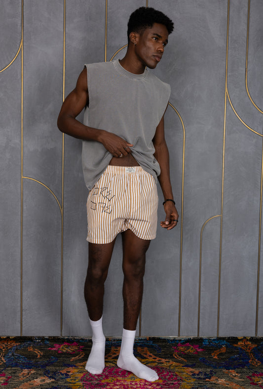 Model wearing a light brown striped ORE OFE boxers with our logo