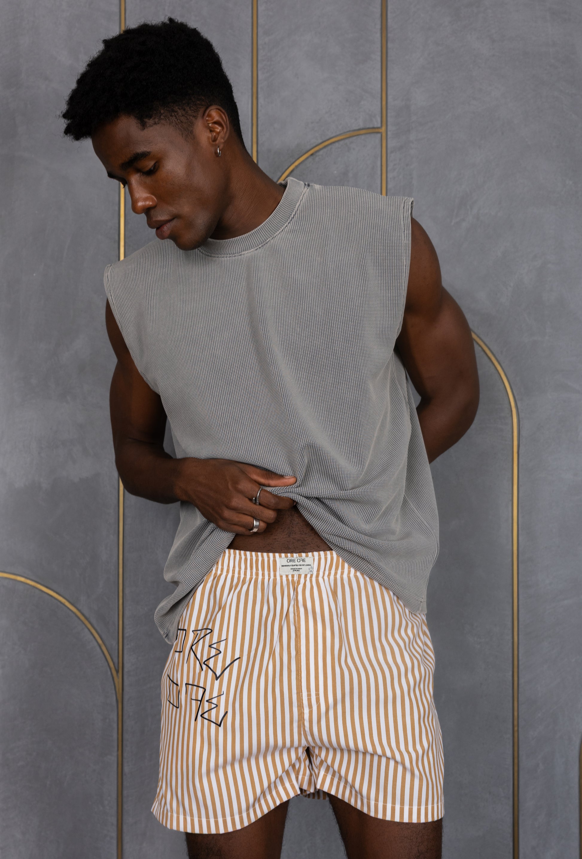 Model wearing a light brown striped ORE OFE boxers with our logo