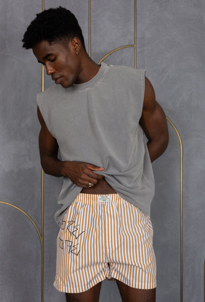 Model wearing a light brown striped ORE OFE boxers with our logo
