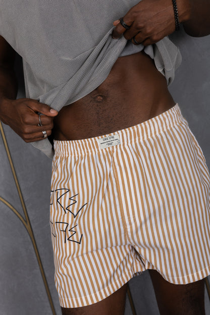 Model wearing a light brown striped ORE OFE boxers with our logo