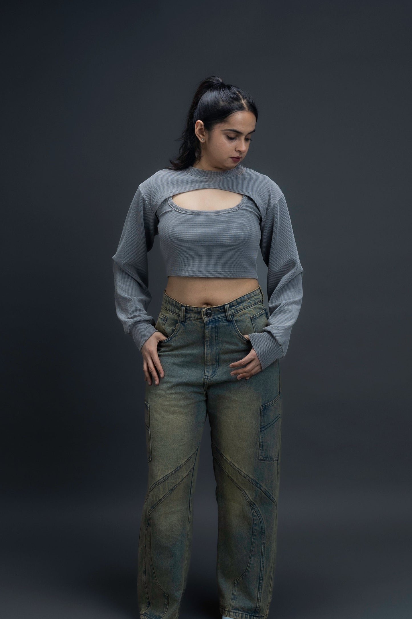 Person wearing ORE OFE's Vintage washed denim that has a pheonix embroided on the back pocket standing against a grey background