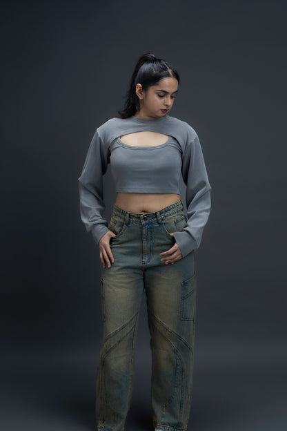 Person wearing ORE OFE's Vintage washed denim that has a pheonix embroided on the back pocket standing against a grey background