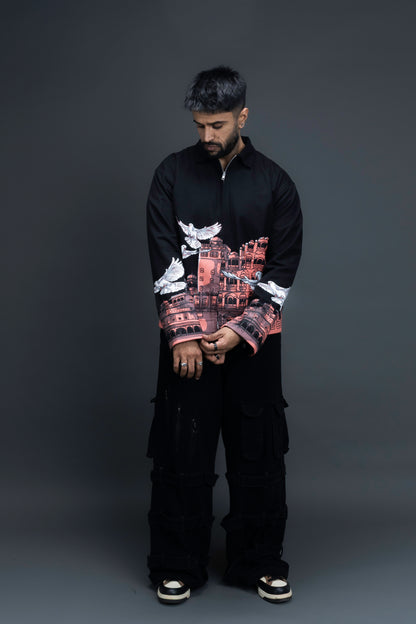 Man wearing ORE OFE's heritage black jacket that is designed on the theme of Hawa mahal standing against a grey background