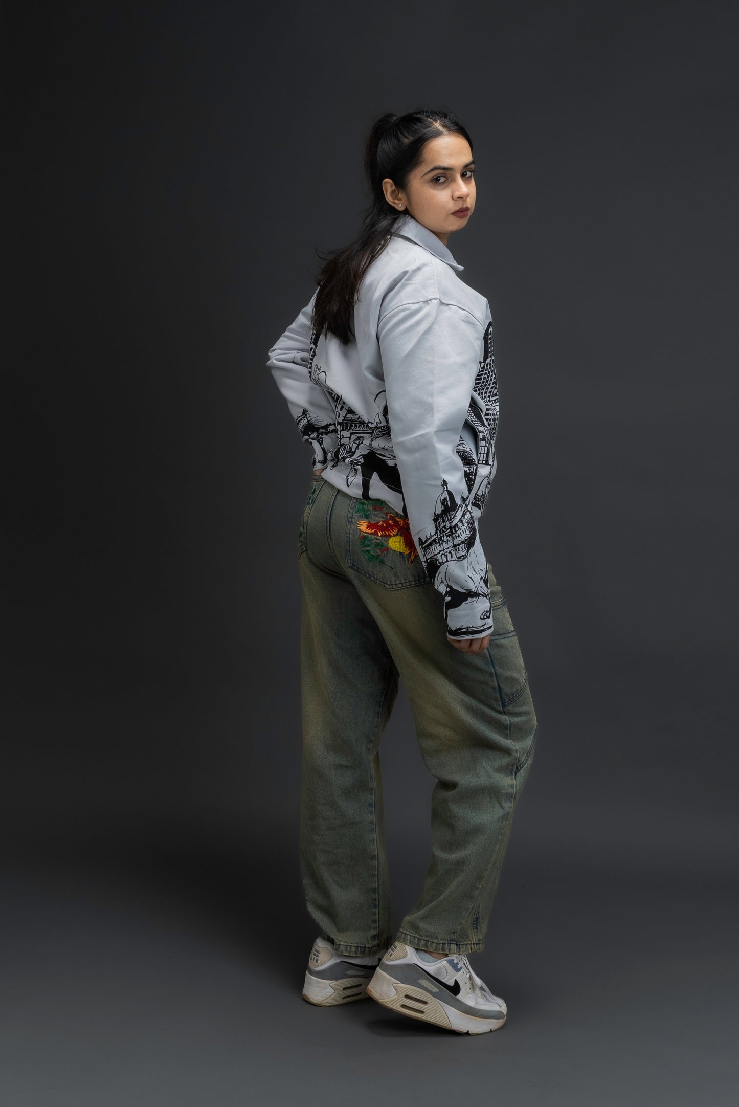 Woman wearing ORE OFE's KHWAB Jacket standing against a gray background