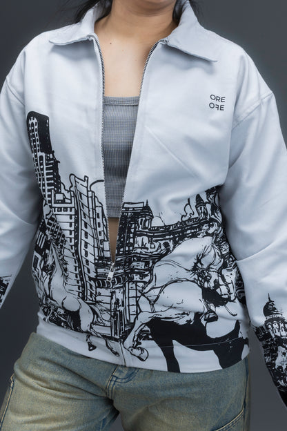 Women wearing a grey jacket with an upper-left chest logo and black cityscape graphic, standing against a dark background