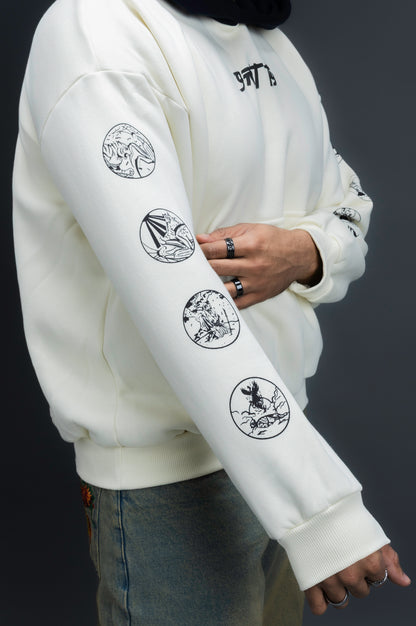 Person wearing a off-white contrast hoodie by ORE OFE with text on the chest that reads GRITTY & design on both sleeves, standing against a black background 