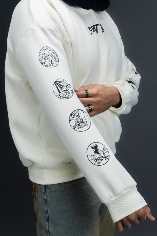 Person wearing a off-white contrast hoodie by ORE OFE with text on the chest that reads GRITTY & design on both sleeves, standing against a black background 