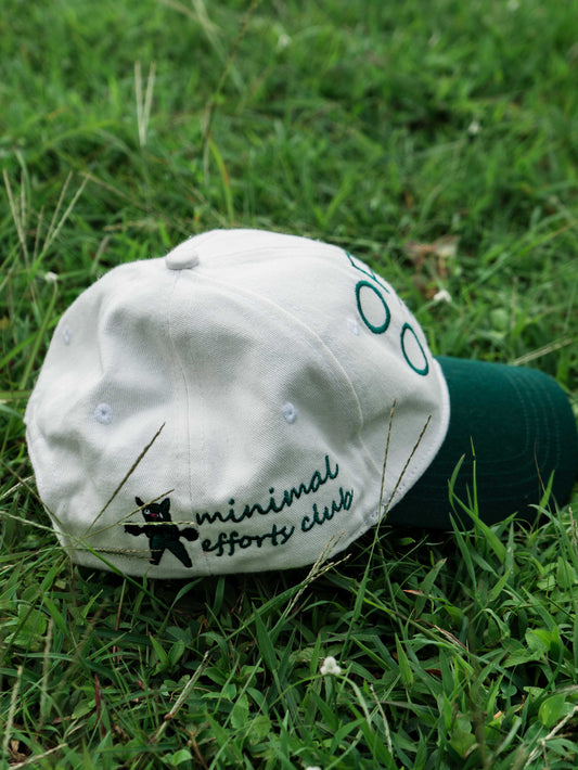 White & Green ORE OFE baseball cap with a design that reads minimal efforts club 