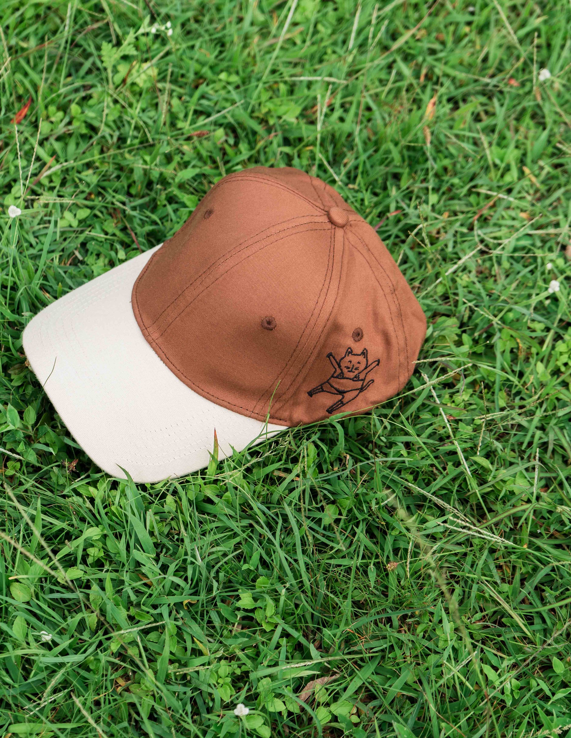Brown & beige baseball ORE OFE cap with a dancing cat printed on it 