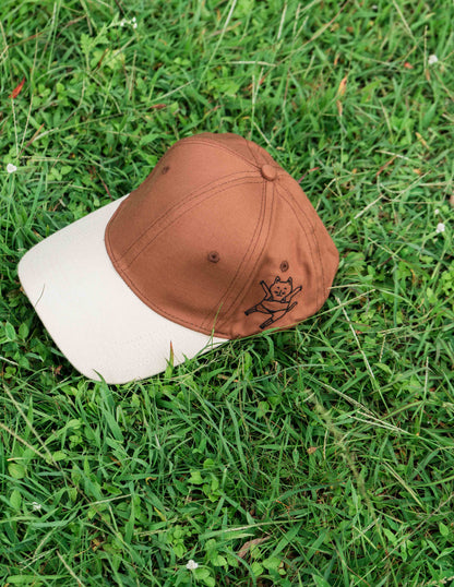 Brown & beige baseball ORE OFE cap with a dancing cat printed on it 