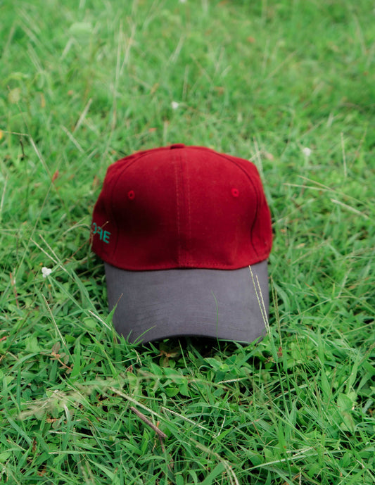 Red & grey ORE OFE baseball cap on grass
