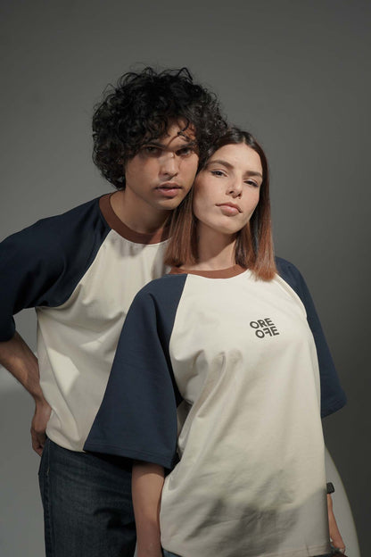 Two people wearing matching baseball tees with a logo on a gray background