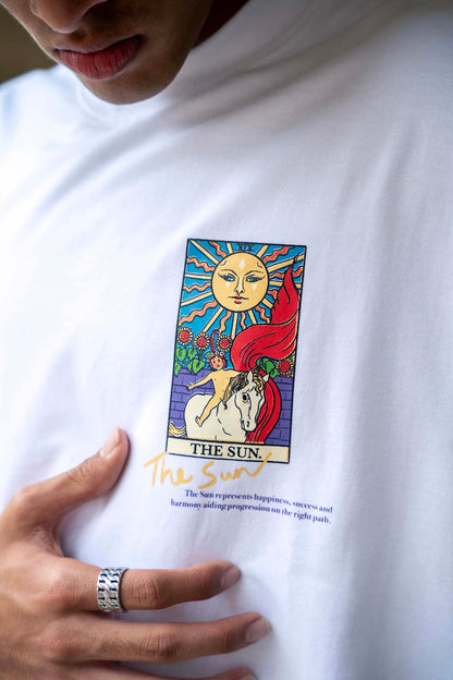 White t-shirt with 'The Sun' tarot card design worn by a person.