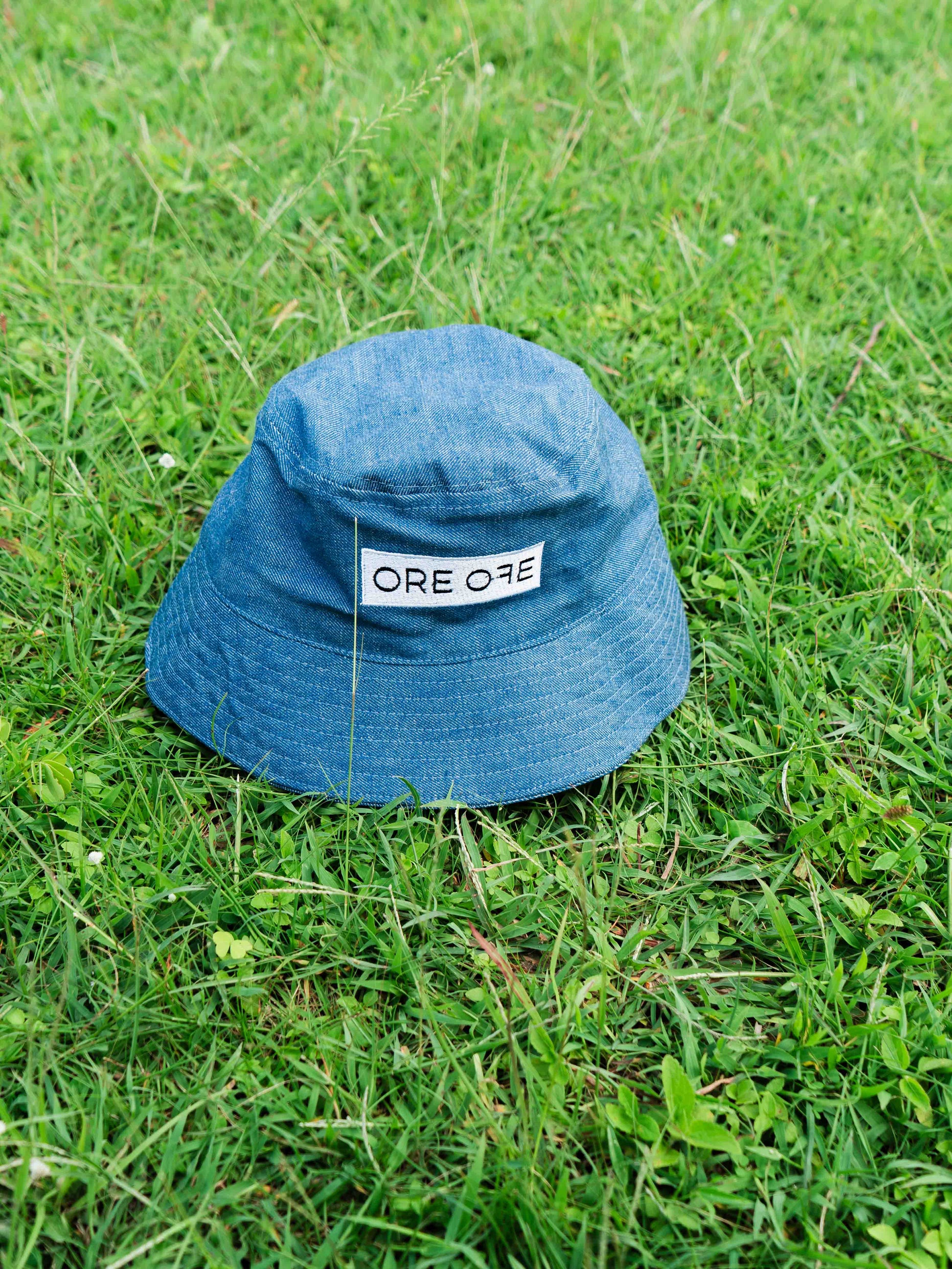 Blue bucket hat with ORE OFE's logo 