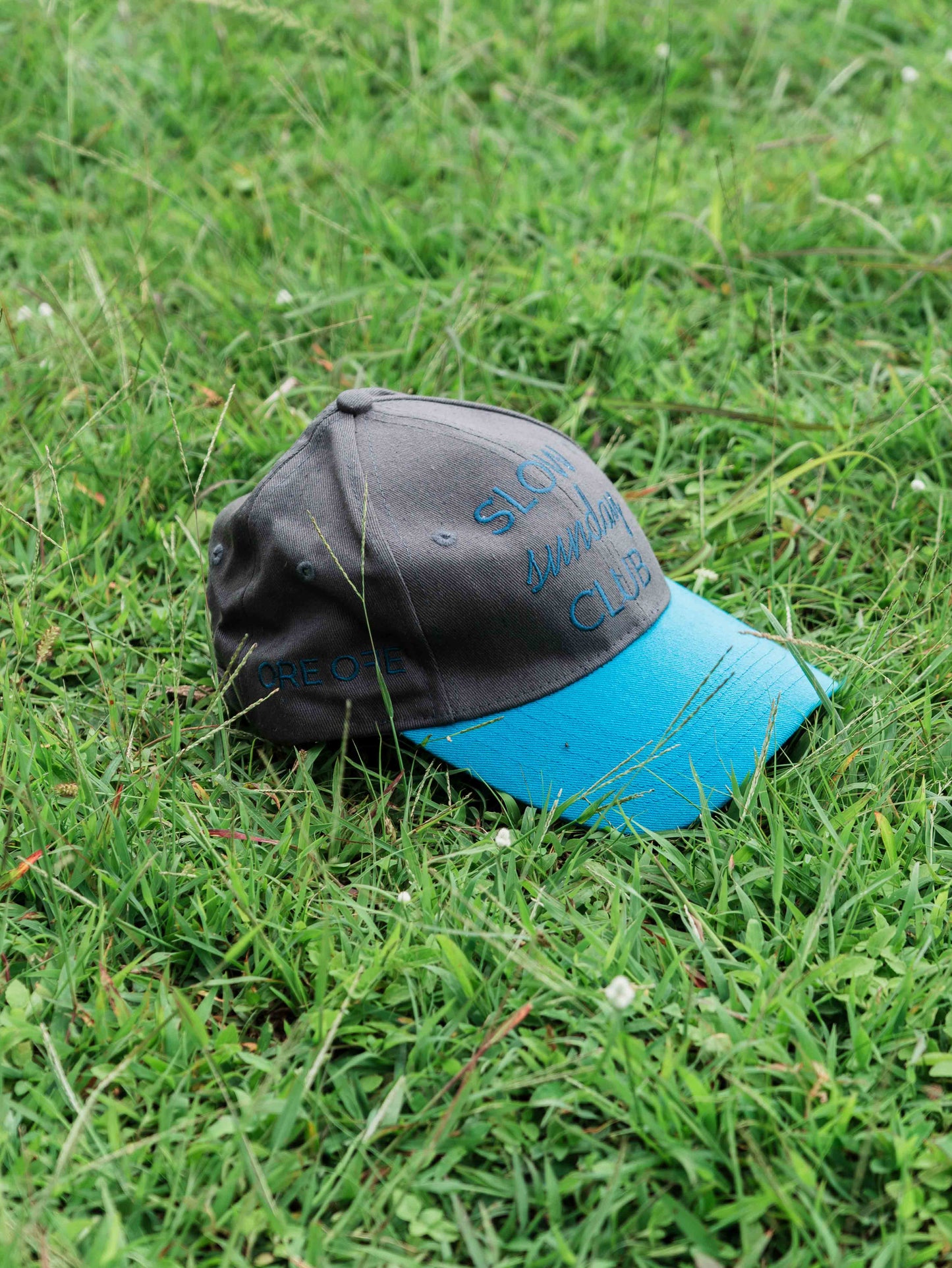 Grey blue ORE OFE cap that reads slow sunday club
