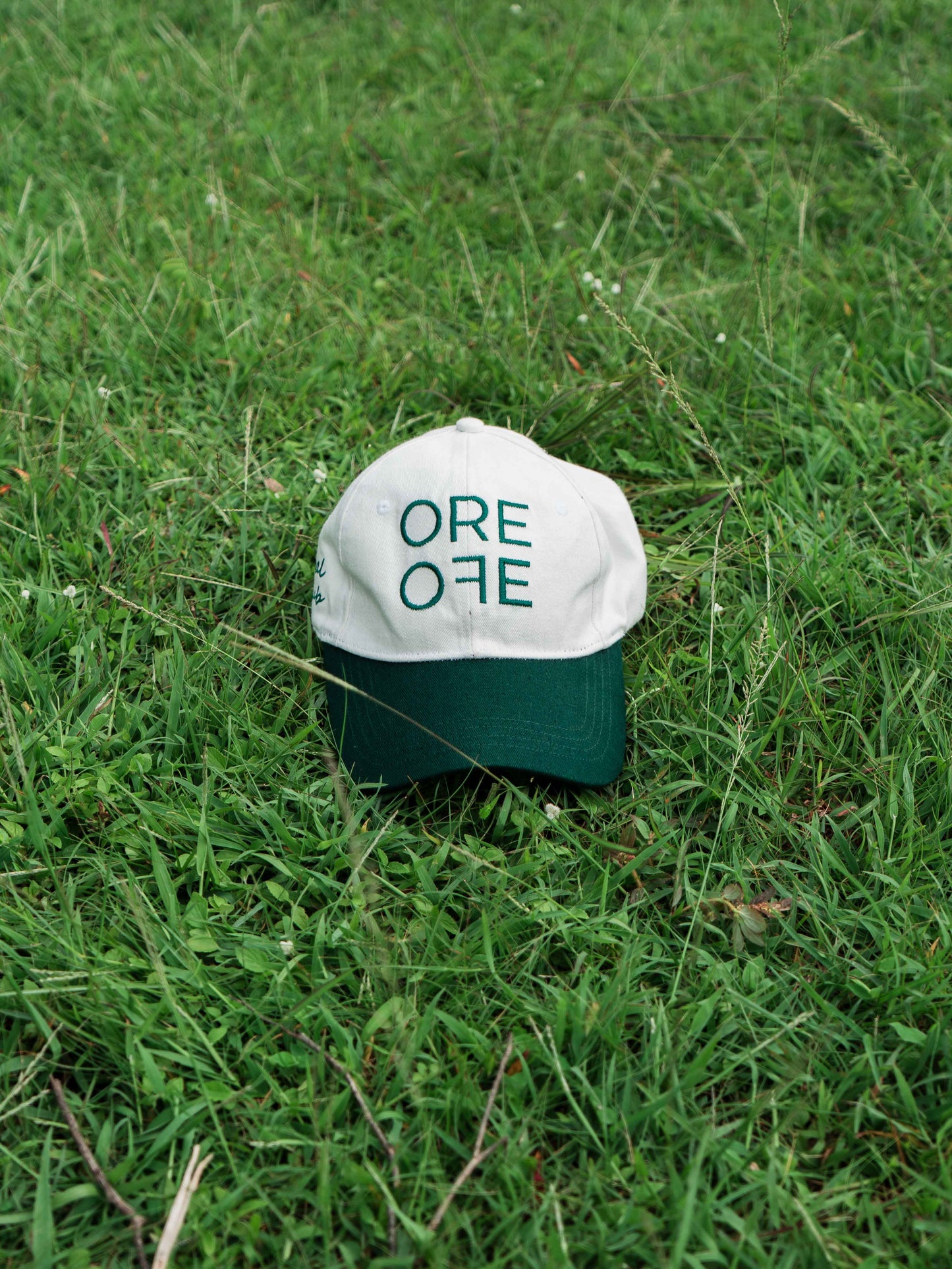 White & Green ORE OFE baseball cap with a design that reads minimal efforts club 