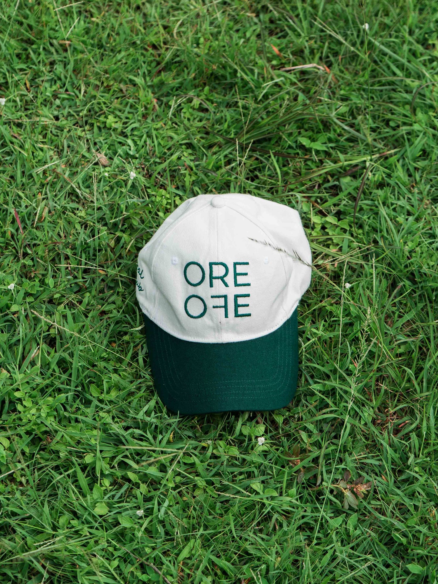 White & Green ORE OFE baseball cap with a design that reads minimal efforts club 