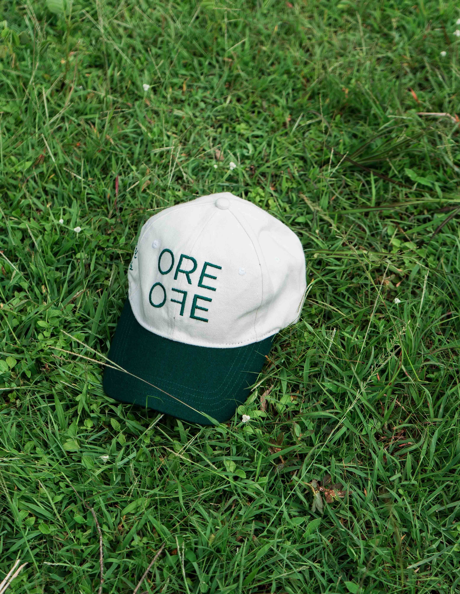 White & Green ORE OFE baseball cap with a design that reads minimal efforts club 