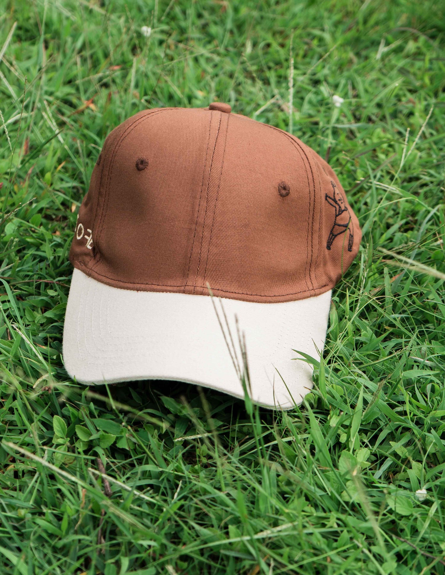 Brown & beige baseball ORE OFE cap with a dancing cat printed on it 