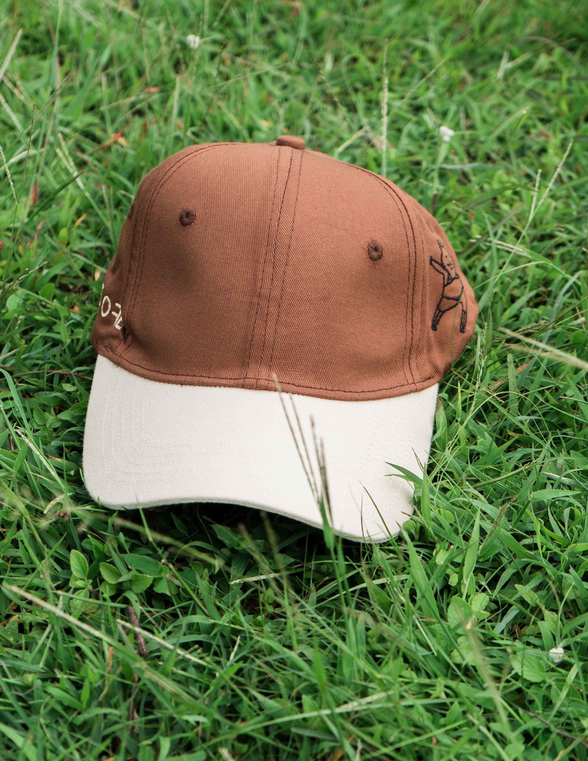 Brown & beige baseball ORE OFE cap with a dancing cat printed on it 