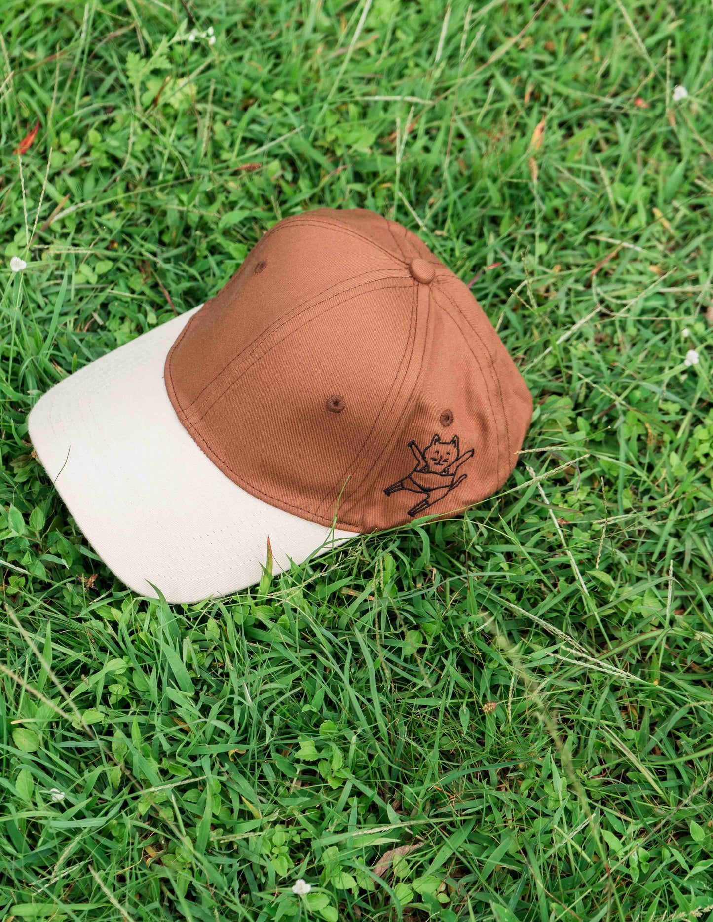 Brown & beige baseball ORE OFE cap with a dancing cat printed on it 
