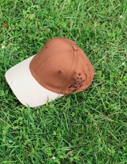 Brown & beige baseball ORE OFE cap with a dancing cat printed on it 