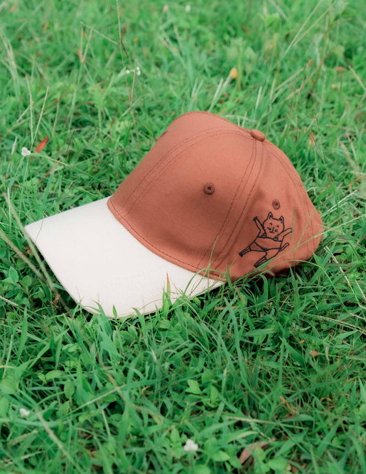 Brown & beige baseball ORE OFE cap with a dancing cat printed on it 