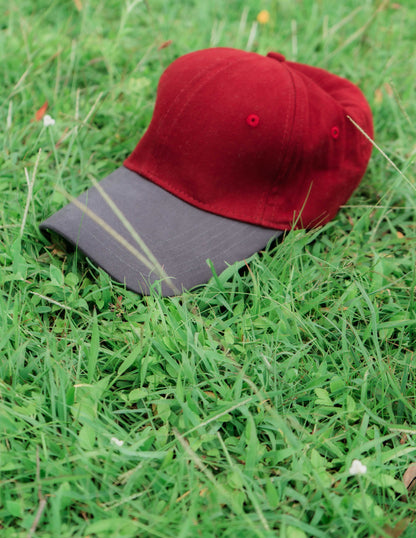 Red & grey ORE OFE baseball cap on grass