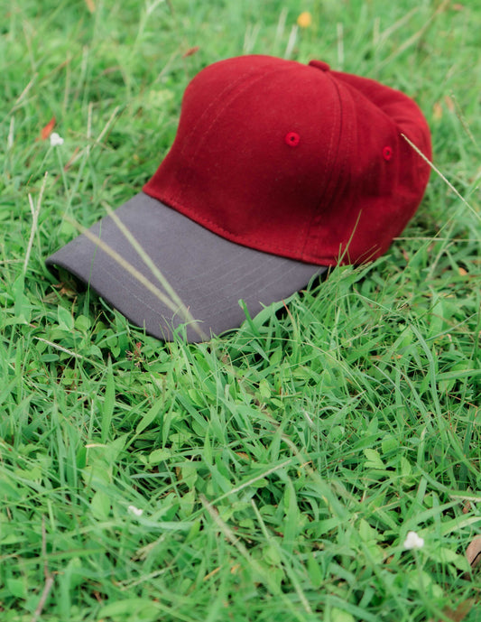 Red & grey ORE OFE baseball cap on grass